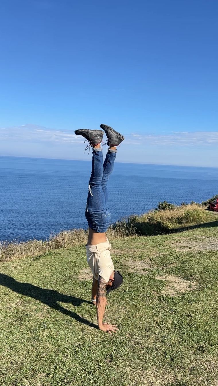 Handstand on a clifftop above the sea