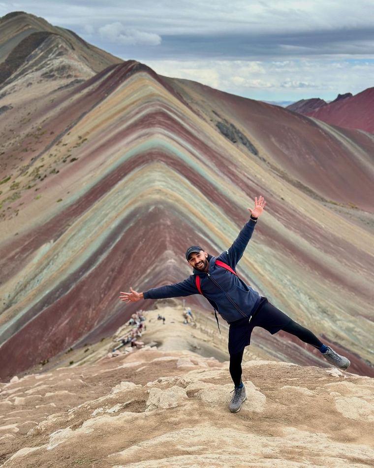 Standing on Rainbow Mountain in Peru